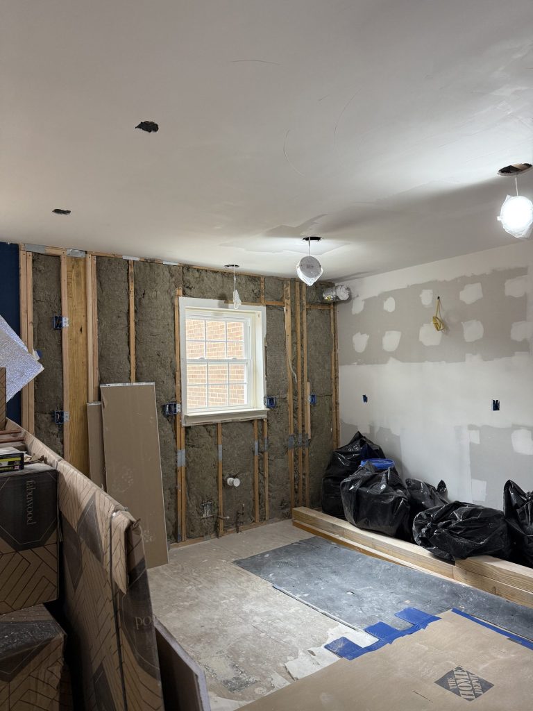 Wall studs and new drywall during construction in Alexandria, VA